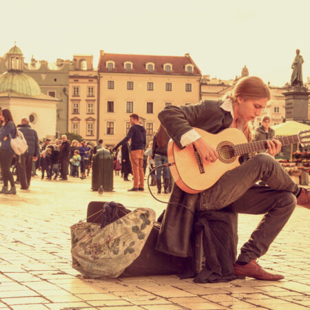 a man playing a guitar on the street