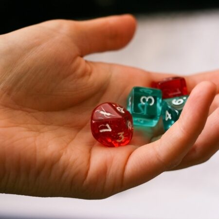 a hand holding four dice